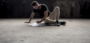 A man drawing alone on the floor